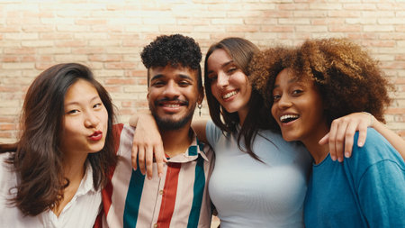 Happy, lovely multiethnic young people posing for the camera on summer day outdoors. Group of...
