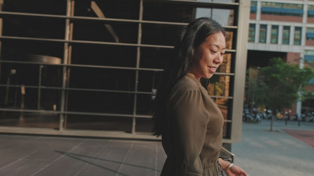 Young businesswoman walking down the stairs of the business centerの写真素材
