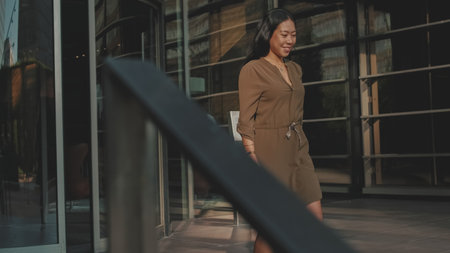 Young businesswoman walking down the stairs of the business centerの写真素材