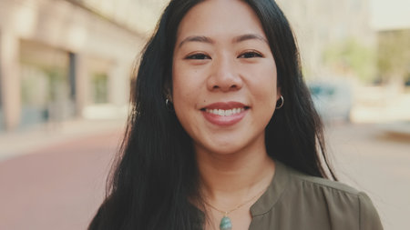 Close-up of young woman looking at the camera and smilingの写真素材