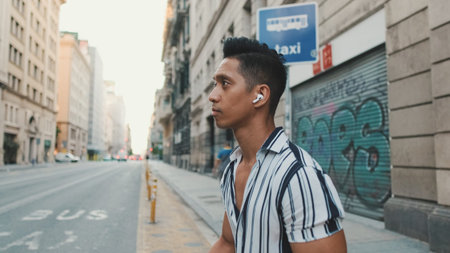 Young man crossing the road