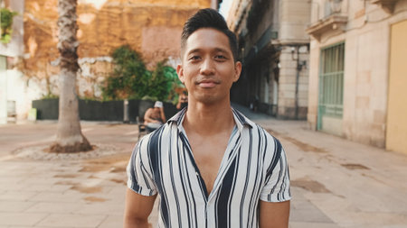 Close up, young man looking at the camera and smiling