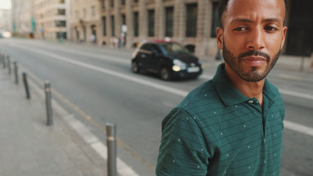 Young man walking down the street on the old town background