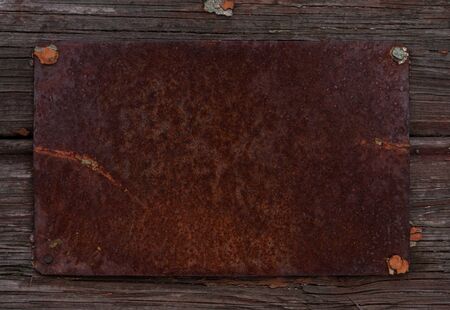 Rusty steel sign on olr wood textureの写真素材
