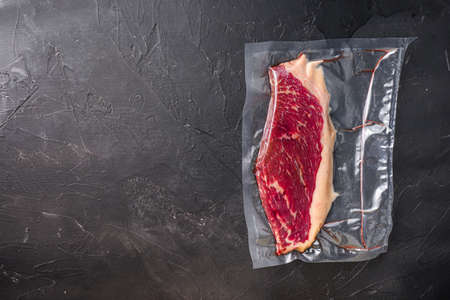 Picanha beef steak for sous vide cooking on black stone background, top view space for textの写真素材