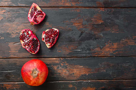 Organic pomegranate over old dark wooden table, top view with space for textの写真素材