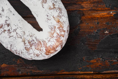 Spanish dry fuet sausage on wooden background.の写真素材