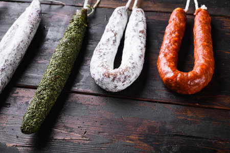Spanish dry sausages on wooden surface.の写真素材