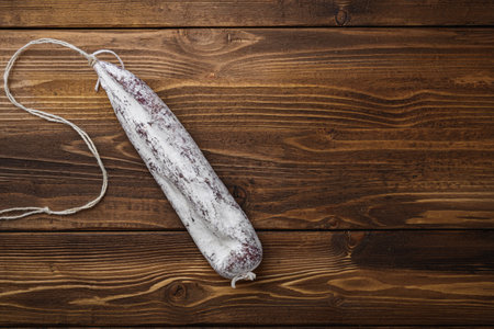 Longaniza fermented white sausage on wood table, topview with space for text.の写真素材