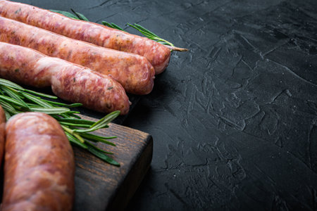 Homemade beef sausages with space for text, on black background.の写真素材