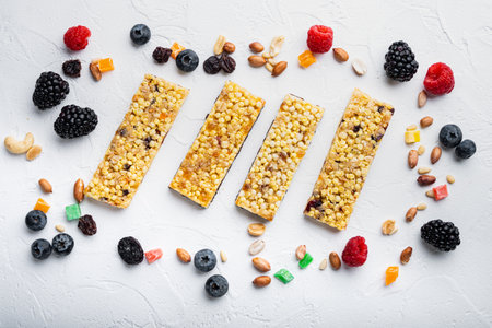 Granola bar and mix of ingredients, flat lay, on white backgroundの写真素材