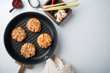 Raw quick asian salmon cutlet, on white textured background, top view with space for textの写真素材