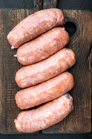 Traditional pork sausages, flat lay, on black background.の写真素材