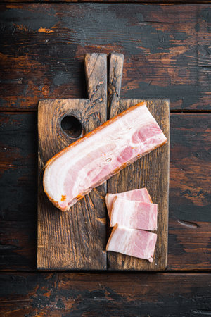 Smoked bacon, whole slab on wooden surface, top view.の写真素材
