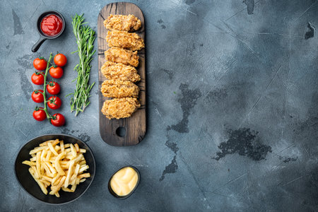 Fried chicken wings parts on gray background, flat lay, with copy space.の写真素材