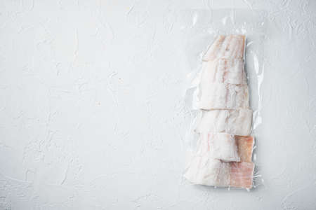 Haddock white fish fillet in plastic market package, on white background, top view with copy space for textの写真素材