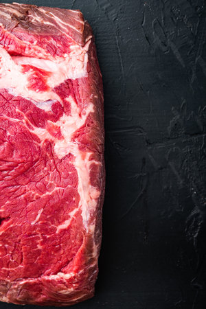 Strip loin steak, raw marbled beef meat, on black background, top viewの写真素材