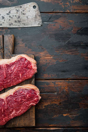 Sirloin steak, uncooked beef meat cut, on dark wooden background, top view, with copy space for textの写真素材