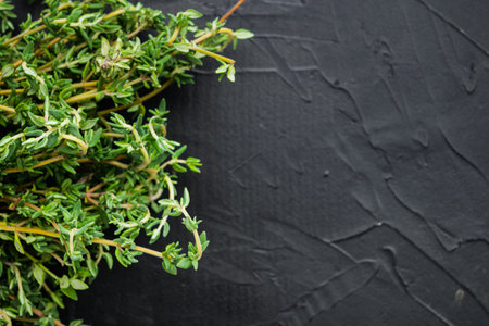 Thyme green fresh bunch, on black background, top view with copy space for textの写真素材