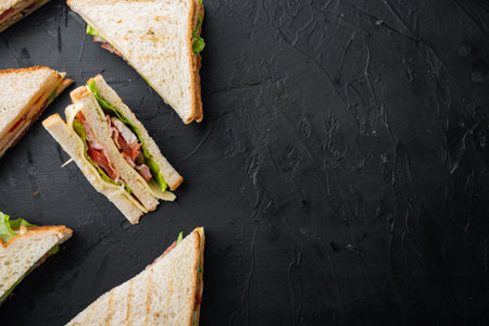 Homemade turkey club sandwich, on black background, top view with copy space for textの写真素材