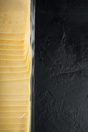 Slices of american cheese plastic pack, on black background with copy space for textの写真素材