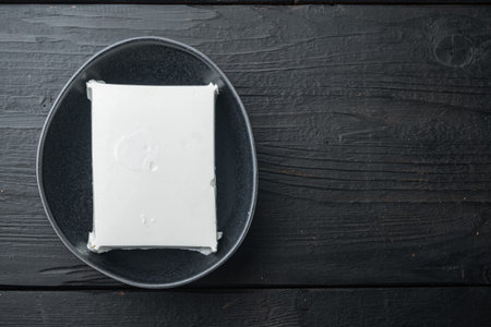 Fresh greek feta cheese set, on black wooden background, flat lay with copy space for textの写真素材