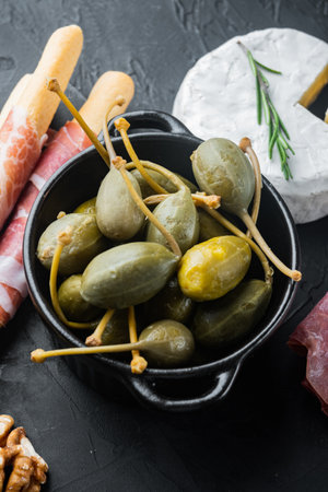Organic pickled, canned capers, on black backgroundの写真素材