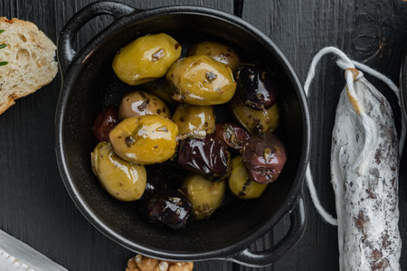 Mediterranean fresh olives, on black wooden table, flat layの写真素材