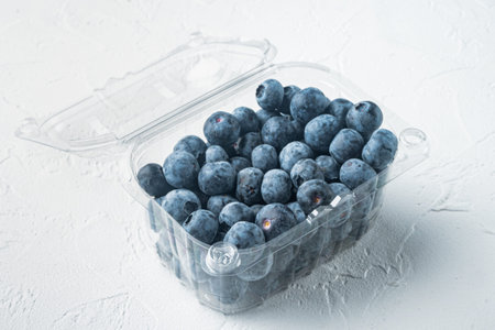 Organic blueberrie in plastic box package, on white background