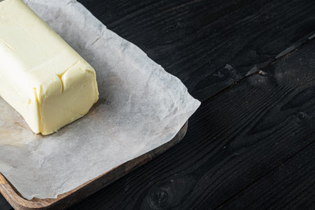 Fresh butter package, on black wooden table background with copy space for textの写真素材