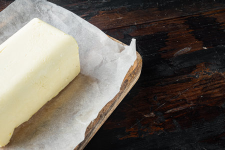Fresh butter package, on old dark wooden table background with copy space for textの写真素材