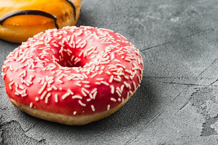 Pink strawberry flavor donuts, on gray background with copy space for textの写真素材