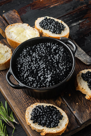 Canape with black sturgeon caviar, on old dark wooden table backgroundの写真素材