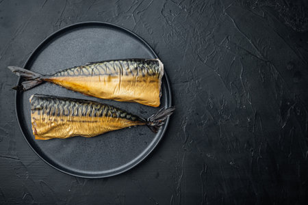 Smoked fish mackerel, on black background, top view flat lay with copy space for textの写真素材
