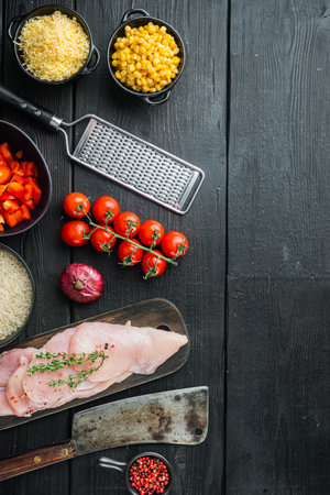 Mexican food ingredients Chicken Enchilada, Rice Casserole, on black wooden table background, top view flat lay with copy space for textの写真素材