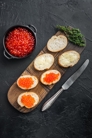 Canape with Red Salmon Caviar, for New Year, on black background, top view flat layの写真素材