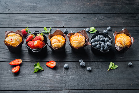 Blueberry muffin, on black wooden table backgroundの写真素材