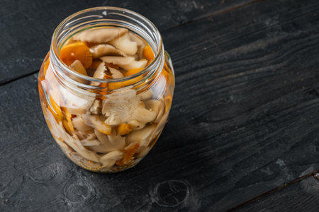 Pickled mushrooms set, on black wooden table background, with space for text copyspaceの写真素材