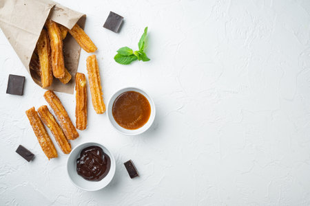 Churros with caramel, Traditional Spanish cusine, on white background, top view flat lay with space for text, copyspaceの写真素材