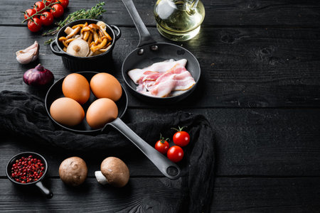 Healthy breakfast ingredients for fried eggs set, on black wooden table background, with space for...