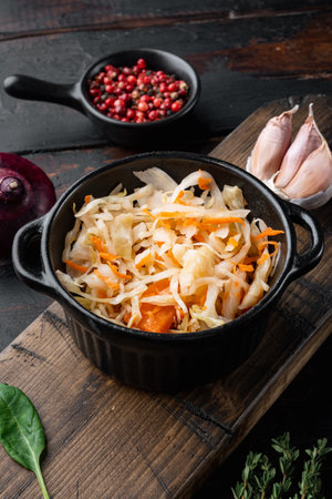 Homemade sauerkraut with cumin set, on old dark wooden table backgroundの写真素材