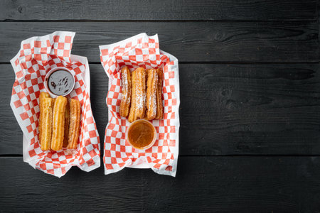 Fried Crullers in Brown, Take Away Bag in paper tray, on black wooden table background, top view flat lay with space for text, copyspaceの写真素材