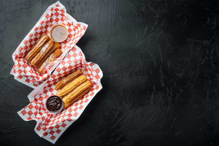 Fried Crullers in Brown, Take Away Bag in paper tray, on black background, top view flat lay with space for text, copyspaceの写真素材