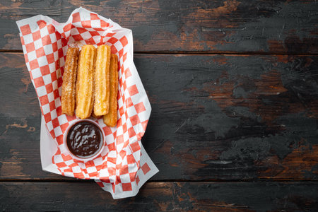 Fried Crullers in Brown, Take Away Bag in paper tray, on old dark wooden table background, top view flat lay with space for text, copyspaceの写真素材