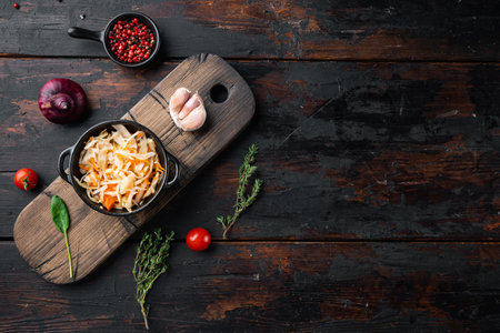 Homemade sauerkraut with cumin set, on old dark wooden table background, top view flat lay, with space for text copyspaceの写真素材