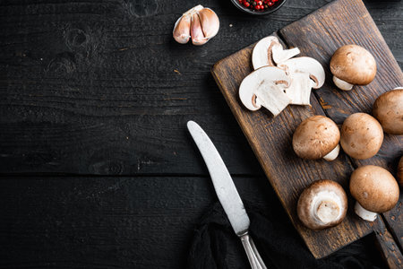 Royal mushrooms champignon whole set, on black wooden table background, top view flat lay, with space for text copyspaceの写真素材