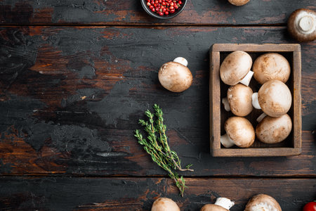 Raw mushrooms champignons set, on old dark wooden table background, top view flat lay, with space for text copyspaceの写真素材