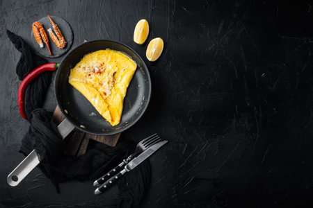 Chilli crab silky omlette, on frying iron pan, on black background, top view flat lay, with copyspace and space for textの写真素材