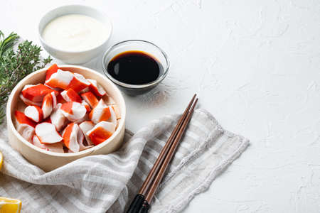 Fresh Crab meat surimi with blue swimming crab set, on wooden tray, on white background, with copyspace and space for textの写真素材