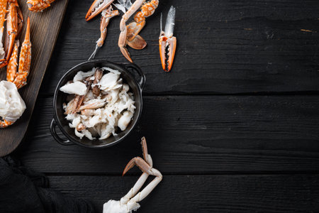 Boiled crab food set, on black wooden table background, top view flat lay, with copyspace and space for textの写真素材